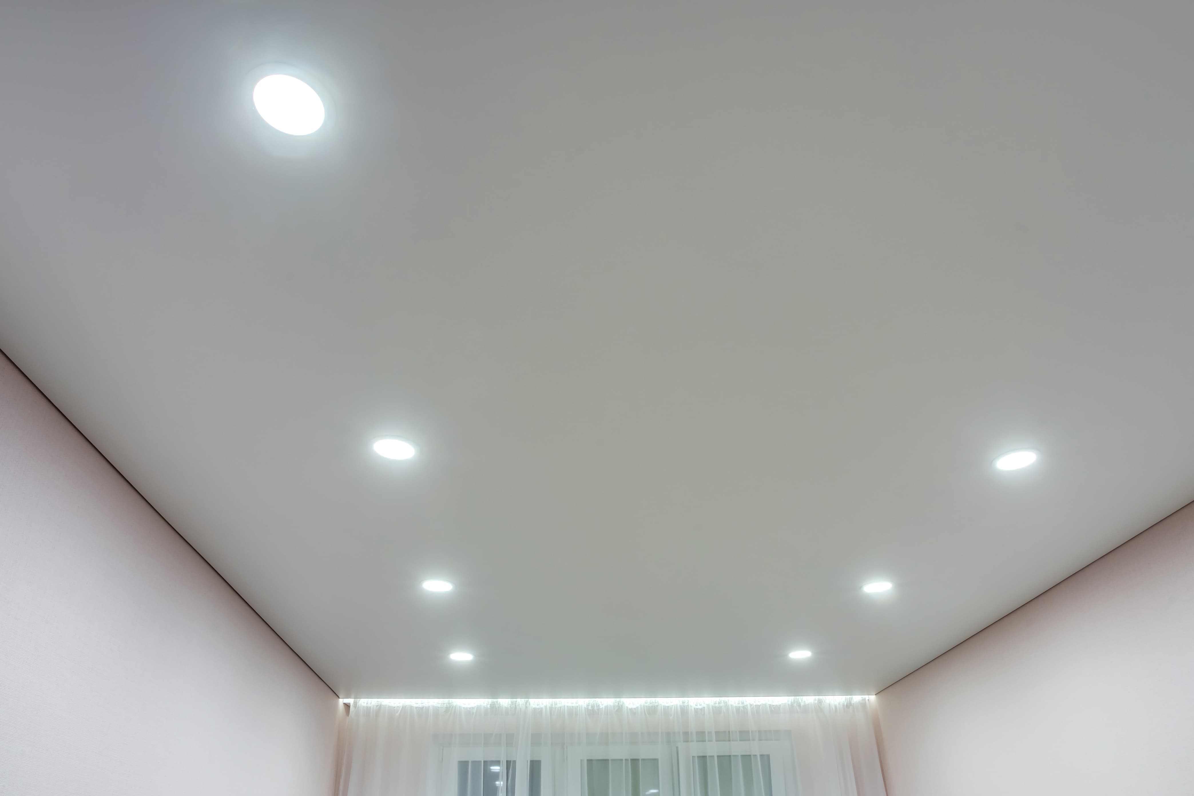 suspended-ceiling-with-halogen-spots-lamps-drywall-construction-empty-room-apartment-house-stretch-ceiling-white-complex-shape.jpg