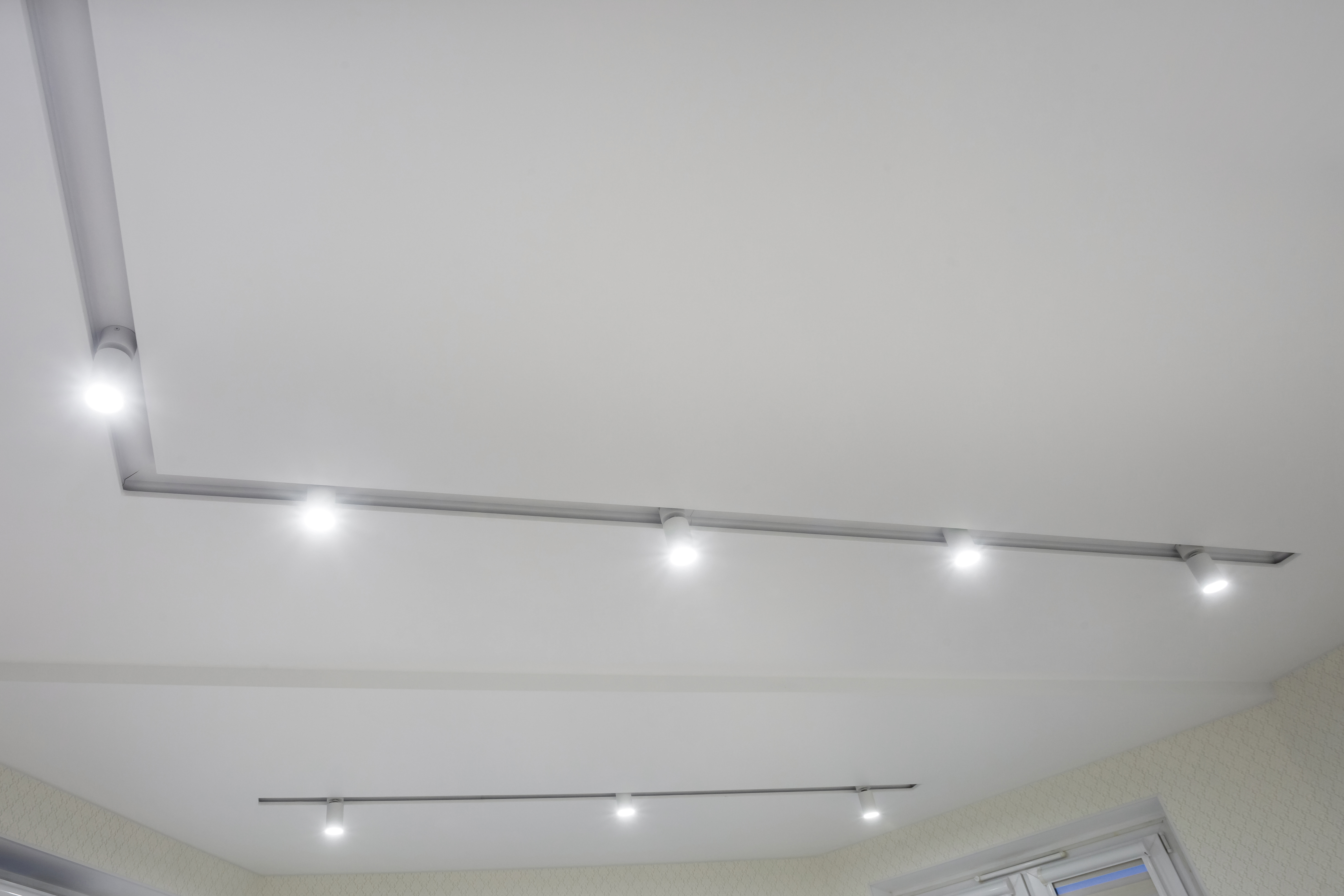 suspended-ceiling-with-halogen-spots-lamps-drywall-construction-empty-room-apartment-house-stretch-ceiling-white-complex-shape copy.jpg